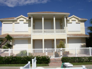 Picture of a large home with hurricane shutters.