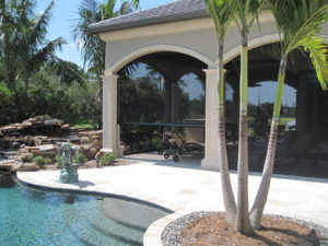 Picture of retractable screens on a house next to a pool.