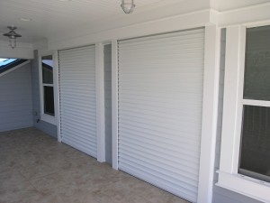 Roll-down shutters over two-sliding doors on a home.