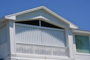 White residential property with roll-down hurricane shutters. 