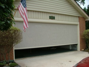 Residential garage with a retractable screen.