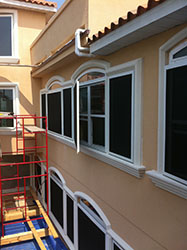 Large home with security screens installed over its windows.